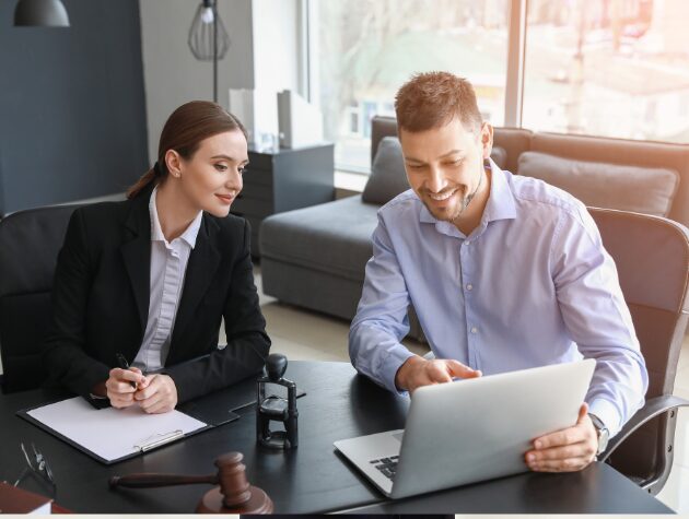 A team of legal professionals collaborating on a laptop, using ESI protocol automation software to streamline drafting, improve accuracy, and save time.