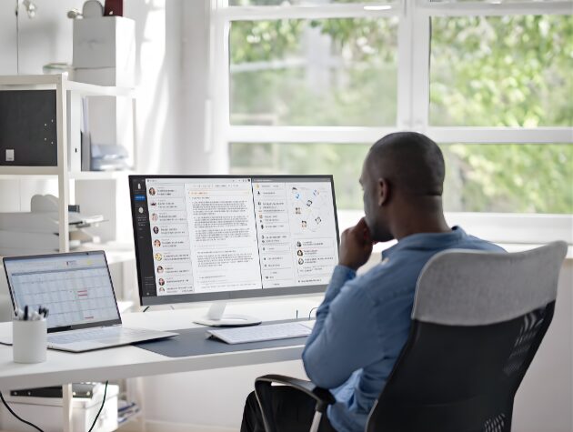 Business leader reviewing communications and ESI litigation insights on a desktop monitor in an office